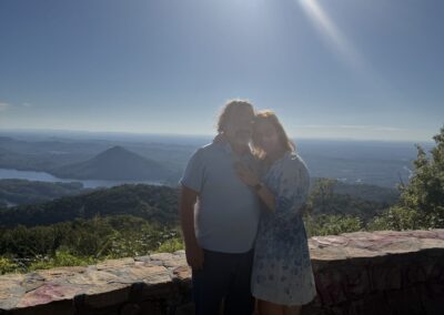 Jonathan and Mary embracing at sunset overlook